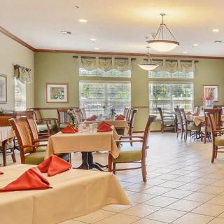 A well-arranged dining room with neatly set tables and chairs in a formal restaurant setting.