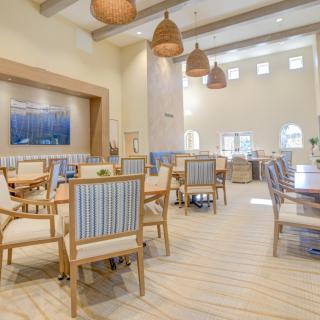 A spacious and modern dining area with comfortable seating and elegant lighting.