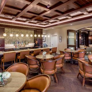 A stylish modern restaurant bar featuring elegant seating and warm lighting.