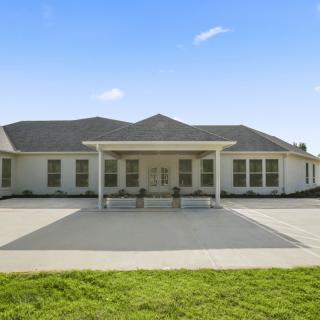 A single-story residential house with a driveway and front yard.