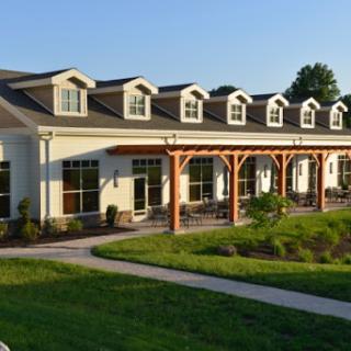 A modern building featuring a welcoming entrance and landscaped surroundings.