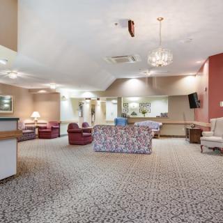 A spacious lounge area featuring comfortable seating and elegant lighting.