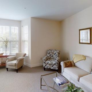 A cozy living room with comfortable seating and ample natural light.
