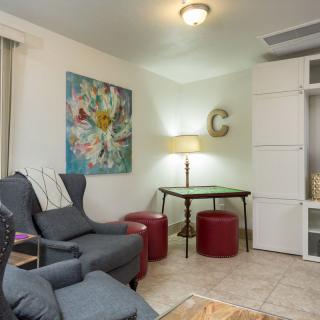 A cozy living room with comfortable seating and artistic decor.