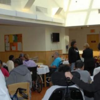A group of people gathered indoors for a community event.