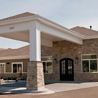 A building with a prominent stone facade and covered entrance.
