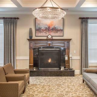 A cozy living room with a fireplace and elegant chandelier.