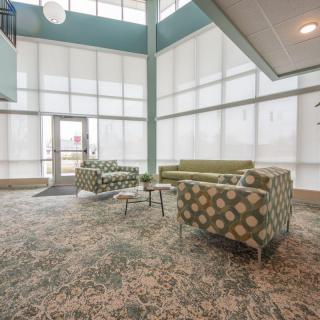 A modern lobby with stylish furniture and abundant natural light.