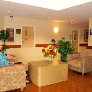 A cozy lobby with seating and decorative plants.