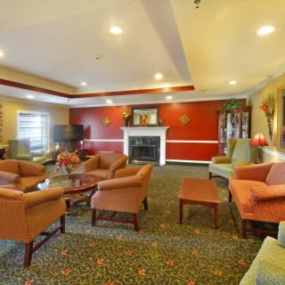 A cozy living room with comfortable seating and a fireplace.