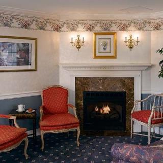 A cozy living room with a traditional fireplace and elegant seating.