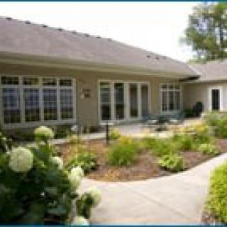 A modern house with a well-maintained garden and large windows.