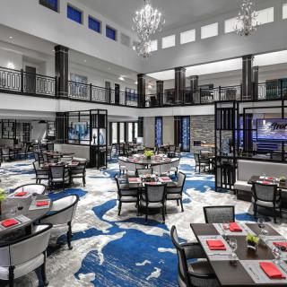 A luxurious and modern restaurant interior with elegant chandeliers and stylish seating arrangements.