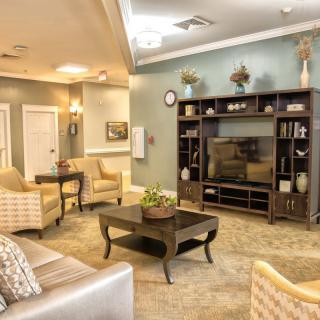 A cozy living room with modern furnishings and a television center.
