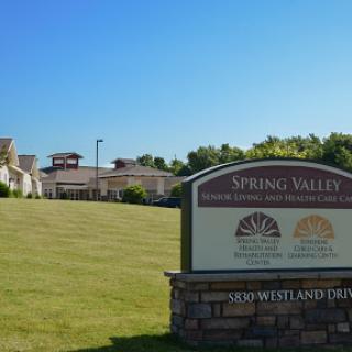Welcome to Spring Valley: A picturesque view featuring the community sign and surrounding landscape.