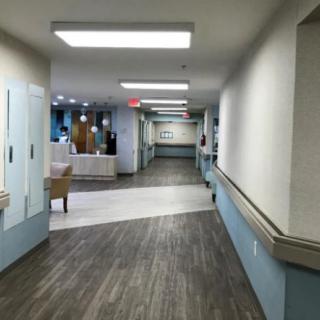 A quiet hospital corridor with bright lighting and modern decor.