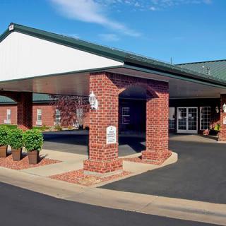 Entrance of a brick building with a covered driveway.
