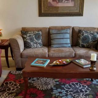 A cozy living room with a sofa, coffee table, and decorative elements.