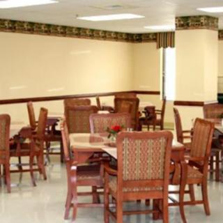 An indoor dining space with wooden tables and chairs.