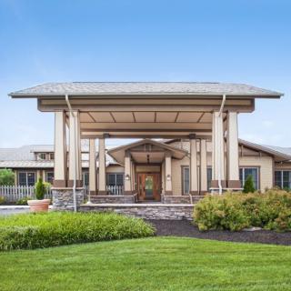 A modern building entrance with a landscaped garden.