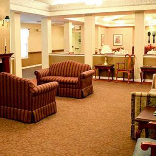 A cozy lobby area with sofas, chairs, and tables arranged for comfort.