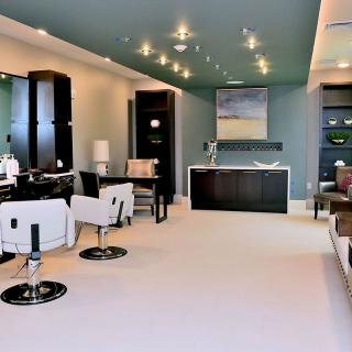 A modern salon interior with stylish furniture and contemporary lighting.