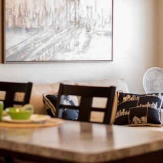 A cozy dining area with a stylish table, chairs, and decorative artwork.
