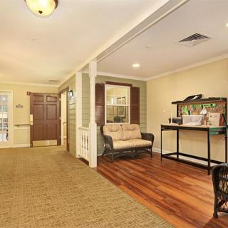 Cozy living room with wood flooring and comfortable seating near the entrance.
