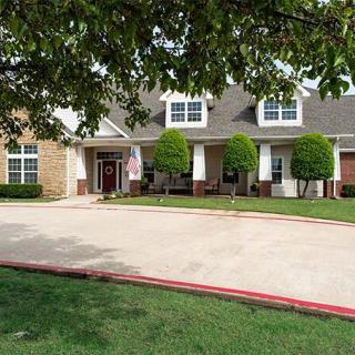 A suburban house with a driveway and well-maintained yard.