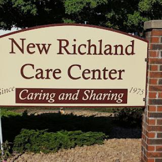 Sign for the New Richland Care Center, highlighting its mission of caring and sharing.