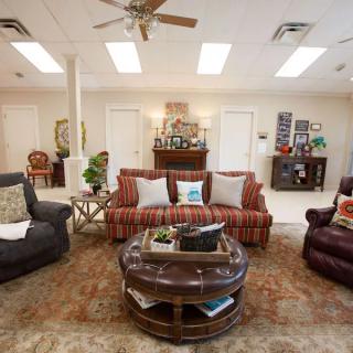 A cozy living room with comfortable seating and a round coffee table.