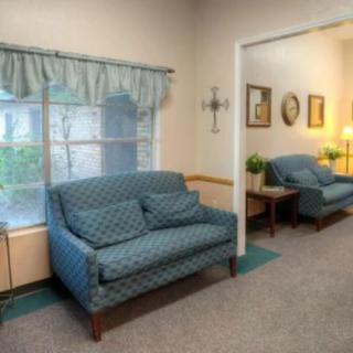 A cozy living room with blue sofas and decor.