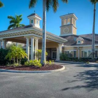 A tropical-style building with palm trees and a welcoming entrance.