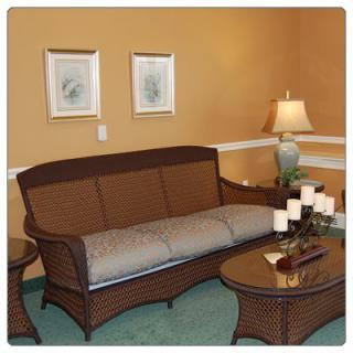 A cozy living room with a sofa, coffee table, and warm lighting.