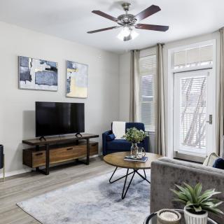A modern living room with a TV, coffee table, and stylish decor.