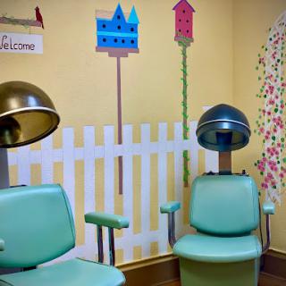 A charming vintage hair salon with colorful decor and retro styling chairs.