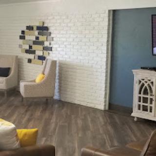 A cozy and modern lounge space with comfortable seating and decorative elements.