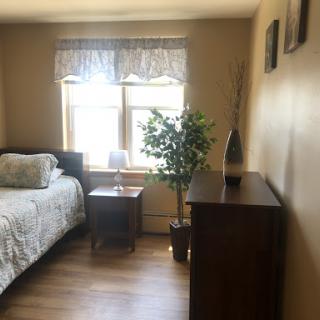 A cozy and well-decorated bedroom featuring warm tones and natural elements.