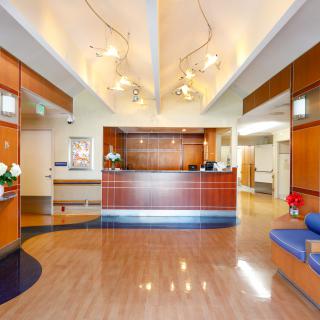 A modern reception area with stylish wood paneling and elegant lighting.