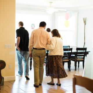 A group of individuals walking together in a bright, airy room.