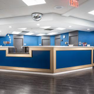 A modern office reception area with blue walls and sleek design.