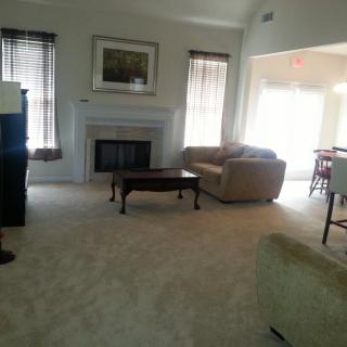 A spacious living room with a fireplace and comfortable seating.