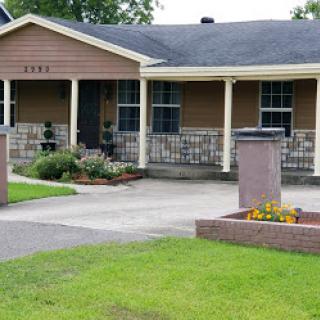 A beautiful residential home with a well-maintained front yard and driveway.