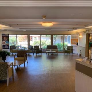 A spacious waiting area with comfortable seating and large windows allowing natural light.