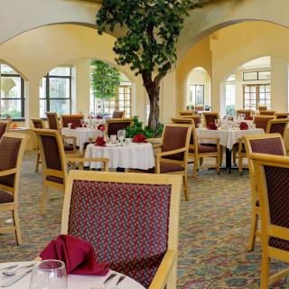 An elegant restaurant interior with neatly arranged tables and chairs.