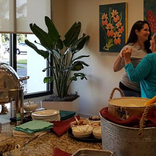 A lively gathering featuring food and conversation in a decorated space.