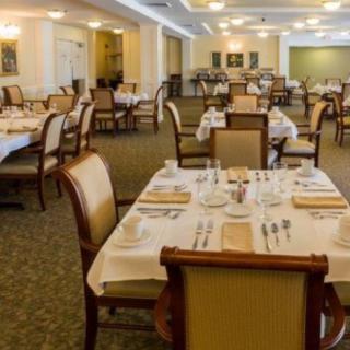 An elegant dining room with set tables and chairs, ready for guests.