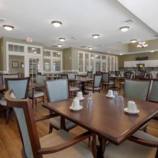 An elegant dining area featuring neatly arranged tables and chairs.