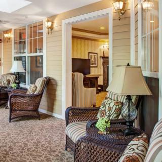 A cozy living room with armchairs and warm lighting.