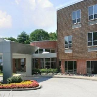 A modern hospital building with landscaped entrance.